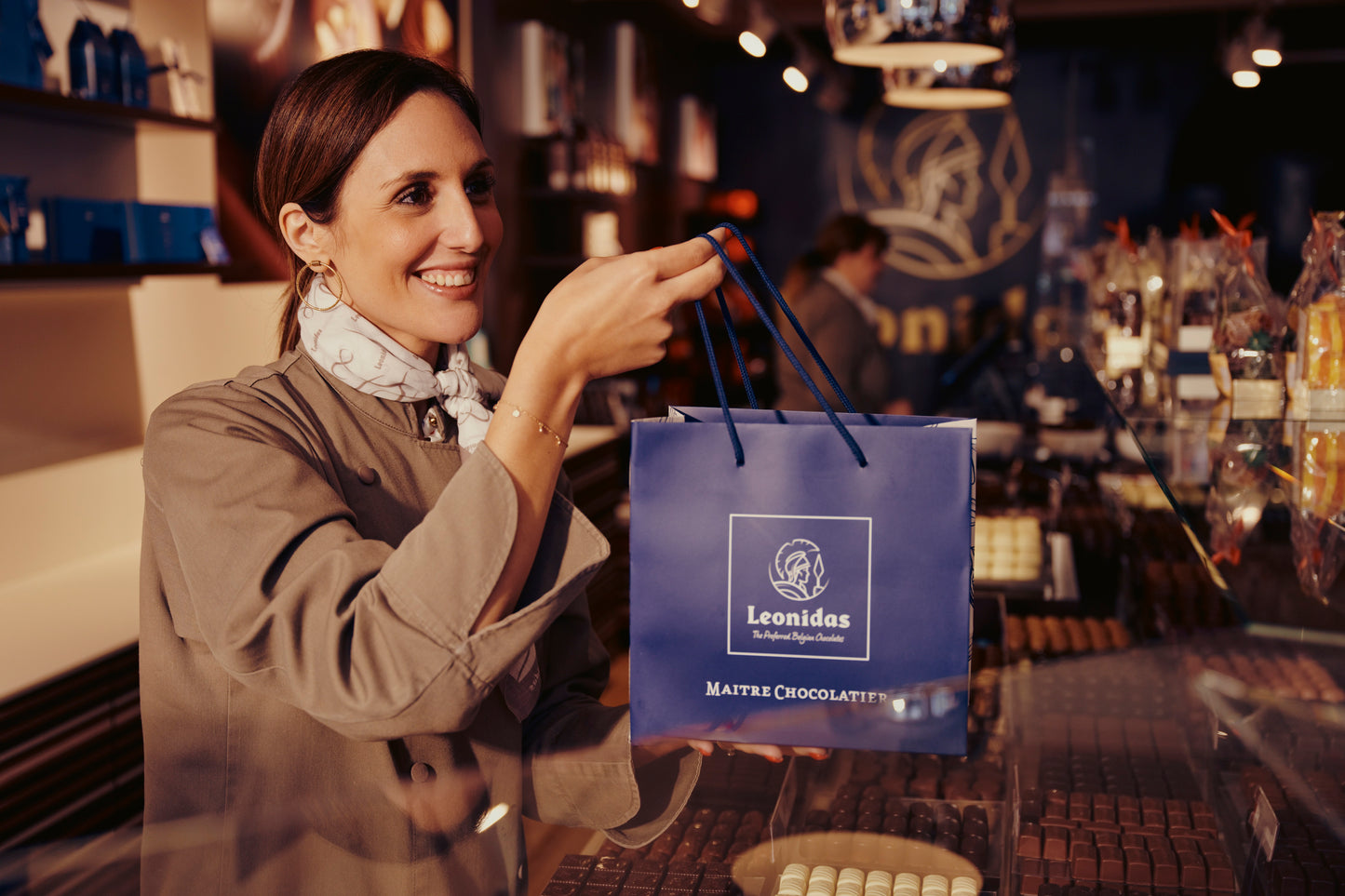 Leonidas bag offered by a store staff