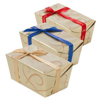 Elegant gift boxes with ribbons, perfect for Belgian chocolate pralines and luxury treats.